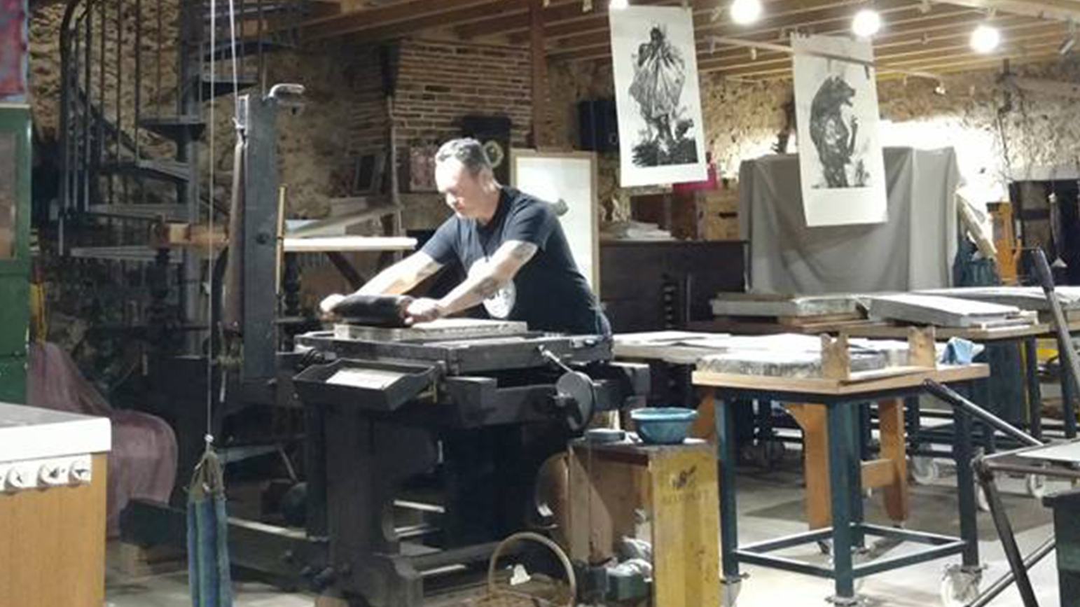 Photograph of a person at a printing press