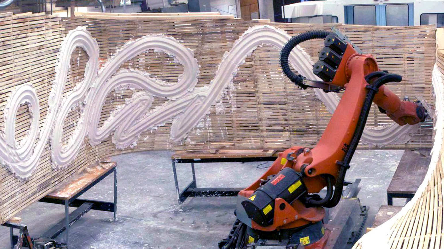 Robot applying plaster to a slatted wall