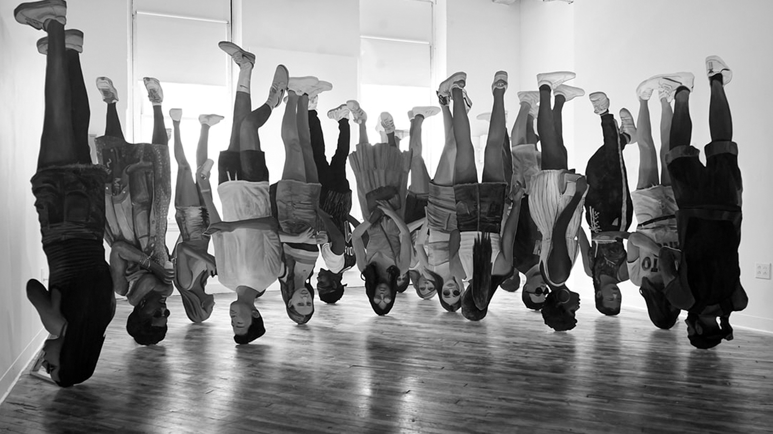 Black and white digitally-created image of a group of people upside down in an empty room
