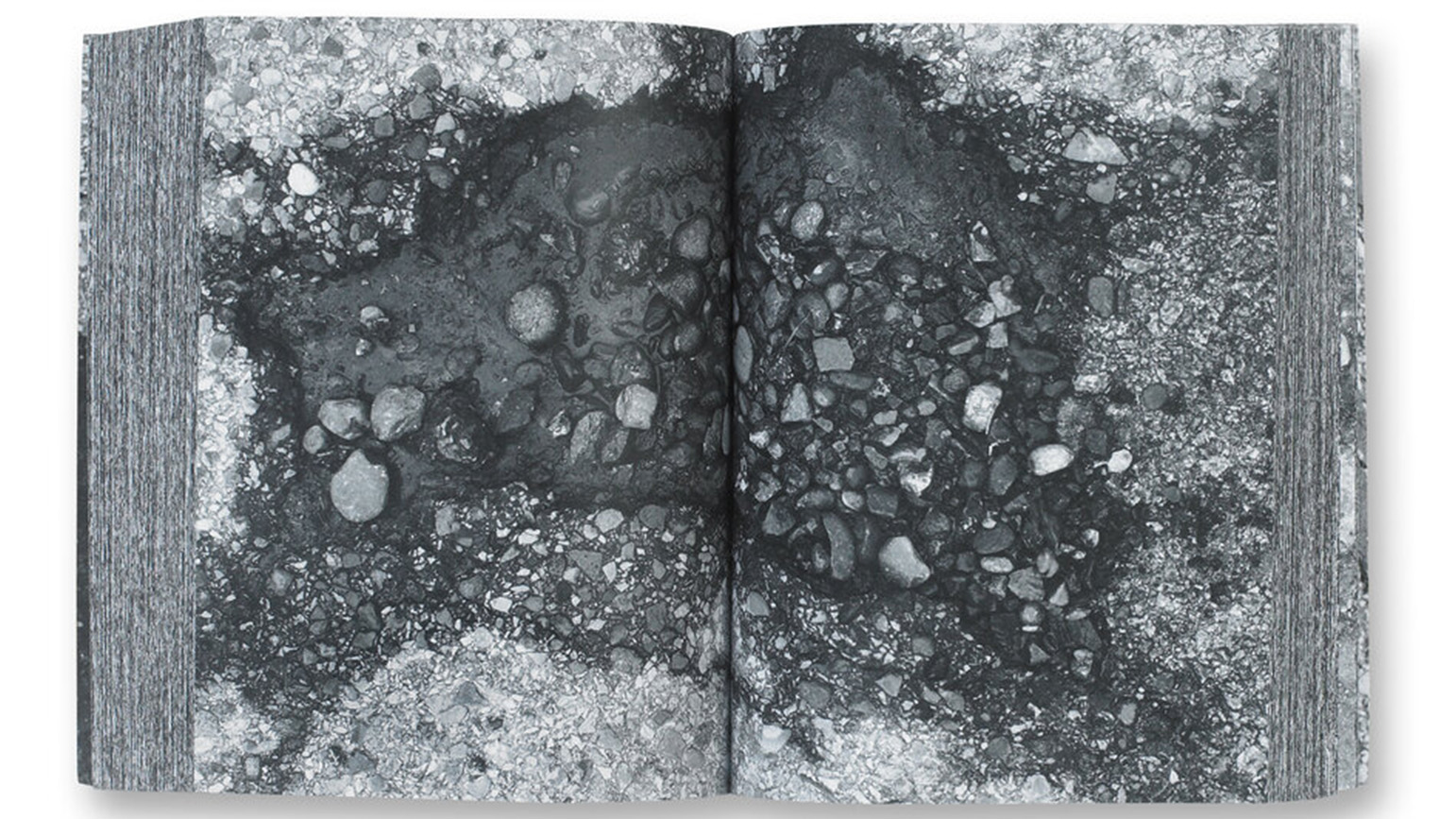 Two-page spread showing a black-and-white close-up photograph of a pothole from Kim Beck's book Pavements, Potholes & Repairs
