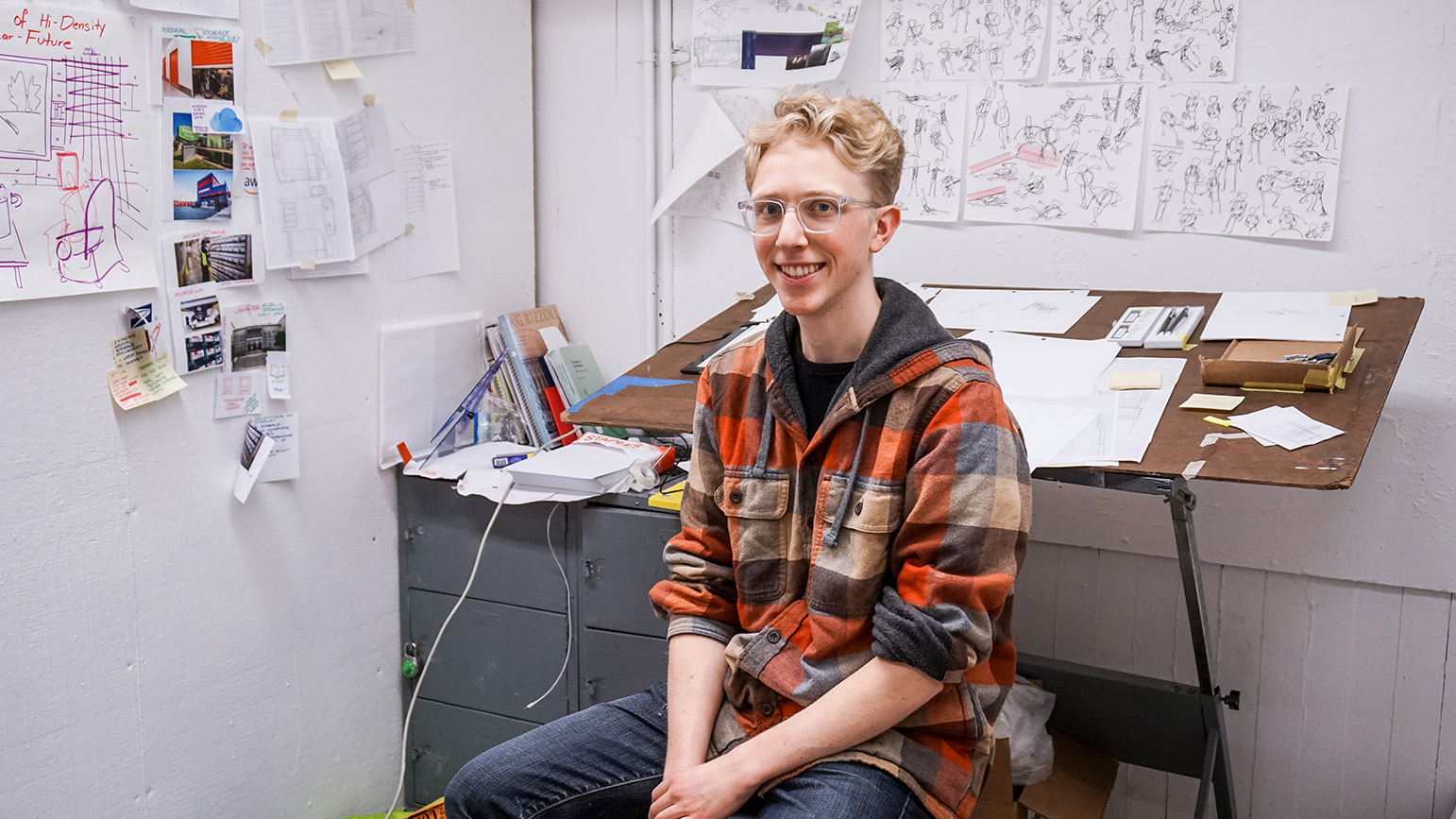 Photograph of Josh Kery sitting in his studio