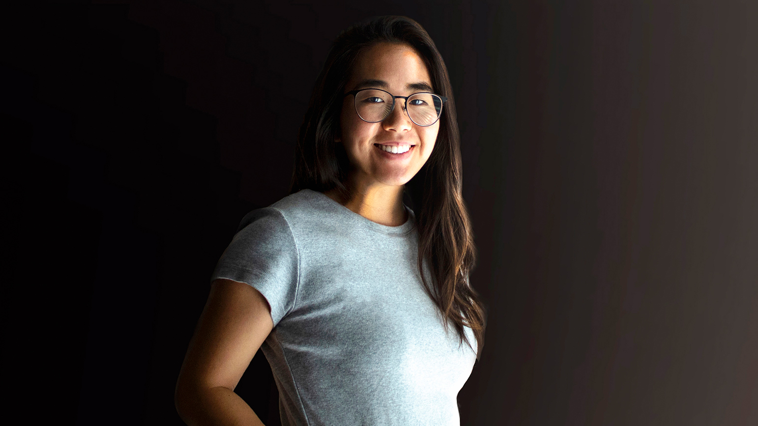 Half length portrait of Selina Lee against a dark background