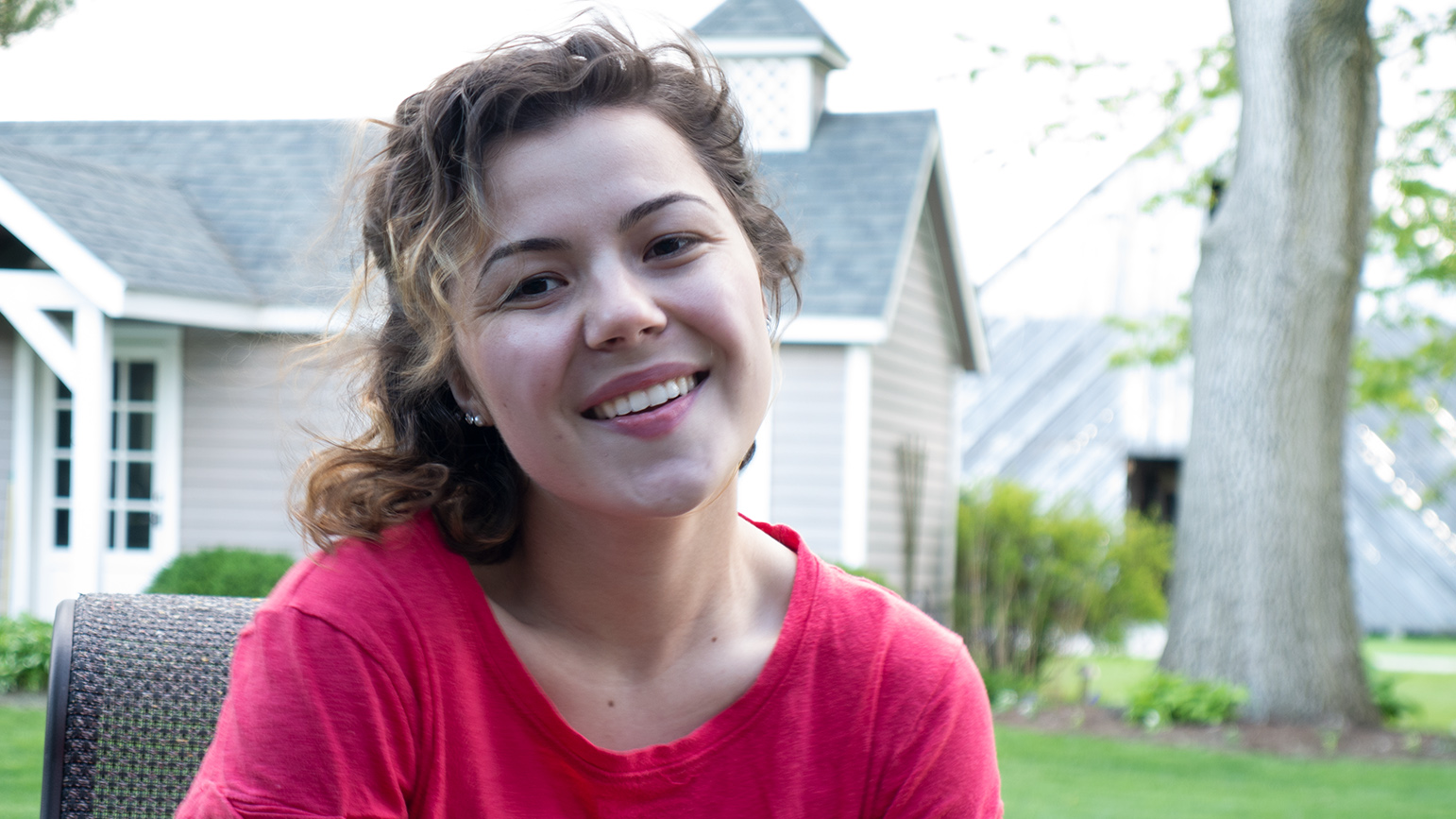 Headshot of Katie Tender outside in front of a house