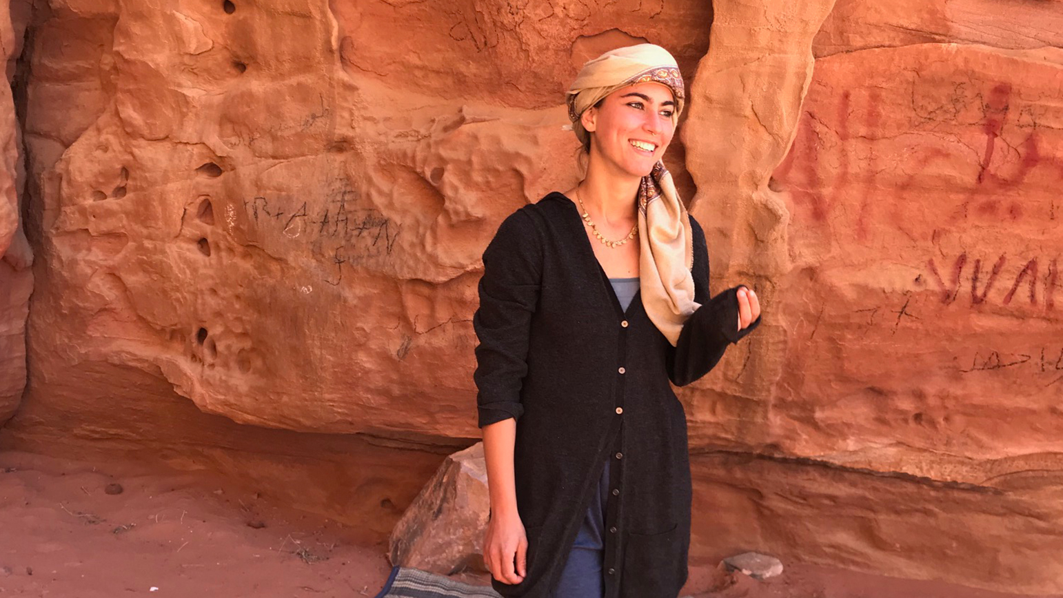 Photo of Liza Goncharova against a red rock wall