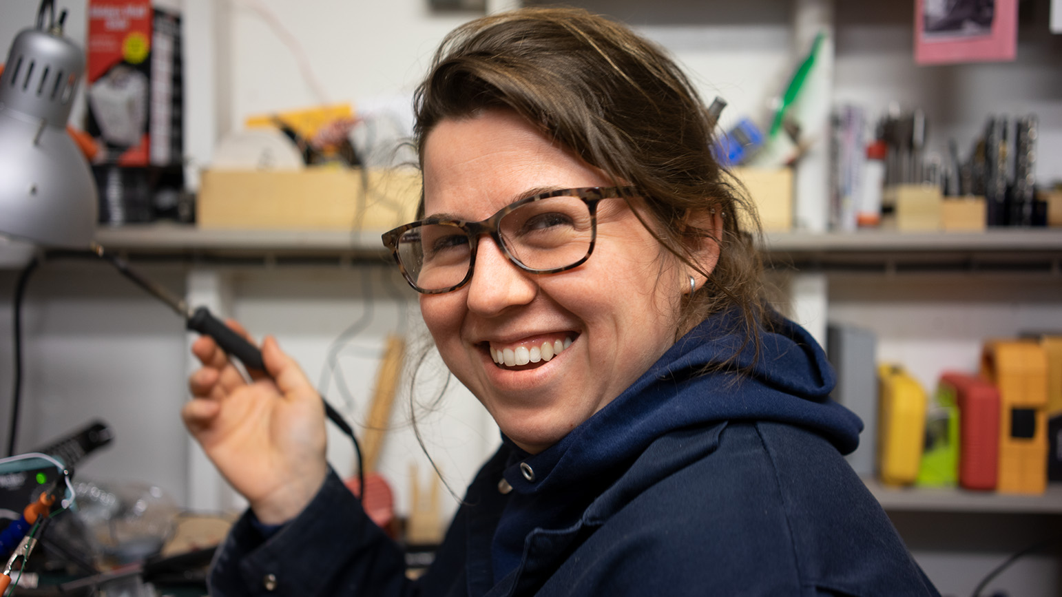 Photograph of Lauren O'Connor-Korb in a sculpture studio