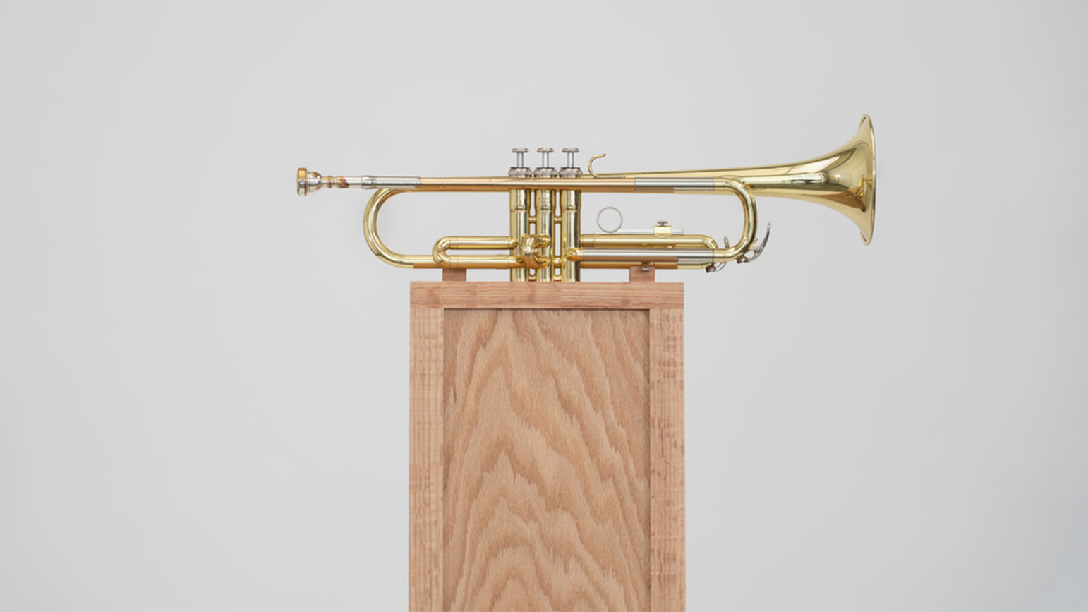 Trumpet mounted to a wood pedestal