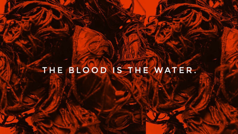 Red tinted image with a close up view of tangled pile of ropes. There is text overlay that reads "THERE IS BLOOD IN THE WATER."